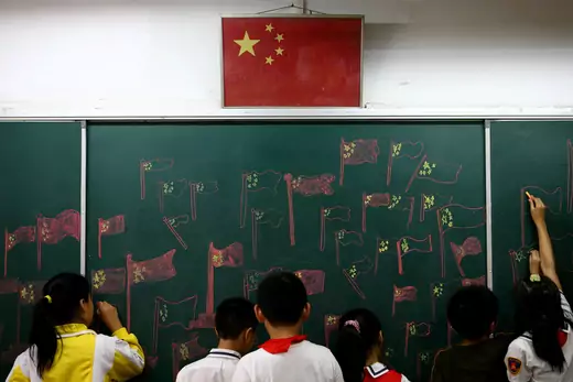 Student draw the Chinese national flag on a chalkboard during an activity to mark National Day September 30, 2007 in Nanjing of Jiangsu Province, China.