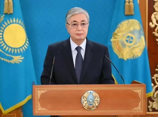 Kassym-Jomart Tokayev, president of Kazakhstan, stands at a podium during a televised address.