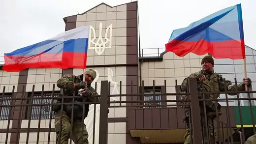 Pro-Russian militia hoist flags of Russia and the separatist self-proclaimed Luhansk People’s Republic in February 2022.