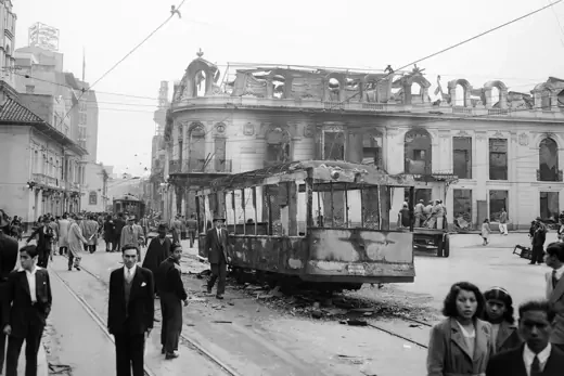 View of destroyed buildings and tram in downtown Bogota after riots.