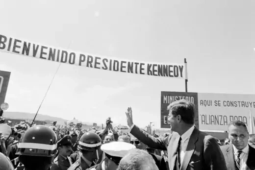 President Kennedy waves to a crowd in Bogota.