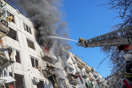 Ukrainian firefighters try to extinguish a fire after an airstrike hit an apartment complex in Chuhuiv, Kharkiv Oblast, Ukraine on February 24, 2022.