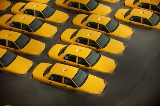 Yellow taxi cabs submerged in floodwaters