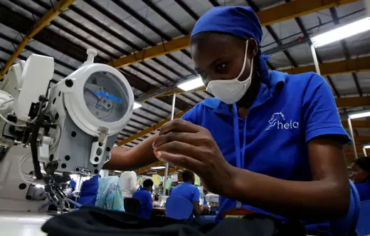 A worker wearing a dust mask sews at an export processing zone factory in Athi River, Kenya.
