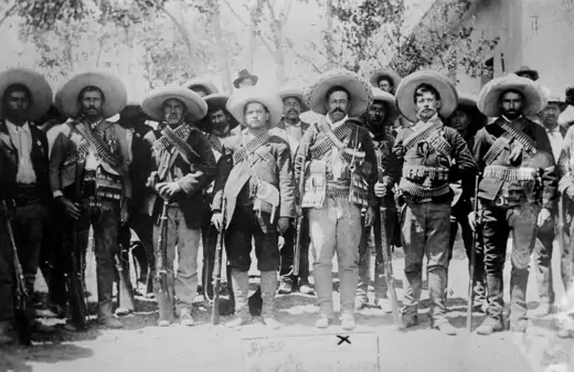 Photo showing Francisco "Pancho" Villa surrounded by several of his men with guns, in Chihuahua, Mexico.