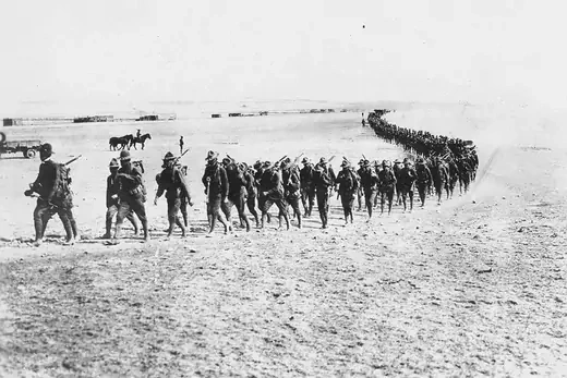 A line of hundreds of members of the U.S. military march across the desert in New Mexico in pursuit of Pancho Villa.
