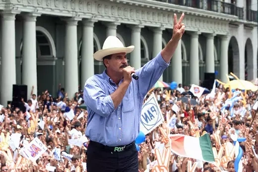 Mexican presidential candidate Vicente Fox makes victory sign to crowd of supporters.