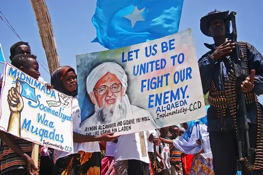 Somalis hold placards as they demonstrate against the Al Shebab Somali rebel group's announcement that they will offically join the Al Qaeda Islamic militant network