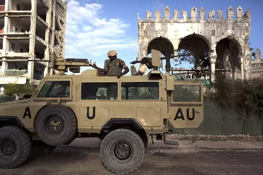 An AMISOM soldier keeps guard on top of an armored vehicle in Mogadishu.
