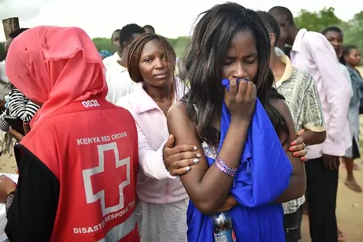 A woman holds another woman who cries after a terrorist attack in Kenya.