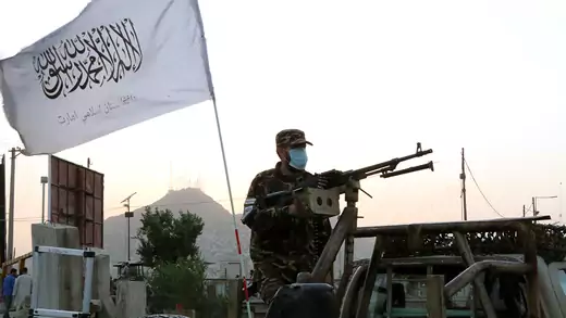 A Taliban soldier manning a machine gun on the back of a vehicle in Kabul.