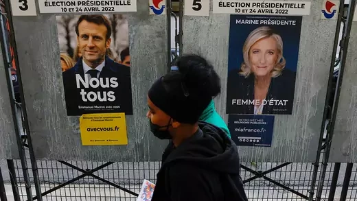 Campaign posters of French presidential election candidates Marine le Pen and President Emmanuel Macron feature on bulletin boards in Paris.