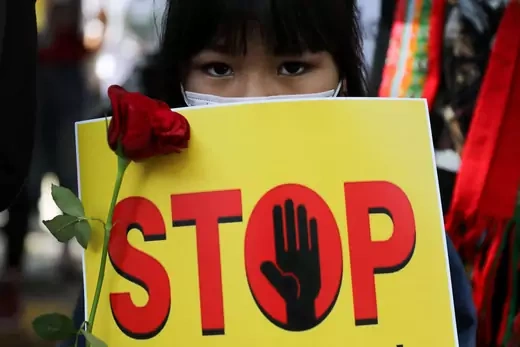 A girl holds a placard reading "STOP" as she attends a protest, organized by pro-democracy supporters, against the military coup in Myanmar and demanding recognition of the National Unity Government of Myanmar, in New Delhi, India, on February 22, 2022.