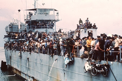 Photo showing a navy ship overflowing with refugees from South Vietnam