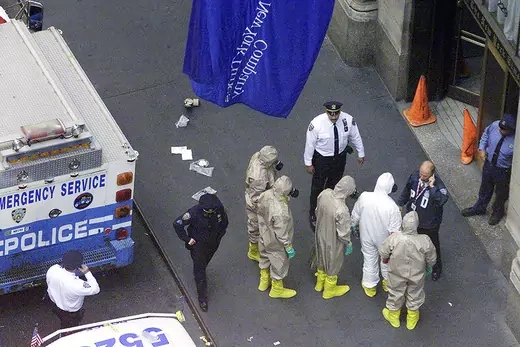 Investigators in protective suits prepare to enter the New York Times newspaper building in New York