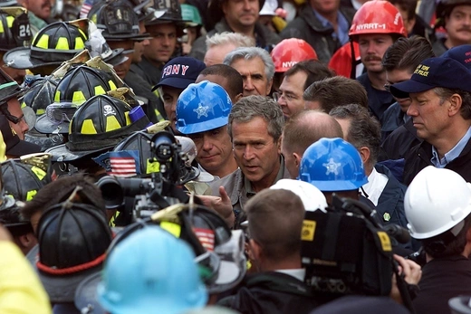 US President George W. Bush talks with firefighters and rescue personnel 14 September, 2001.