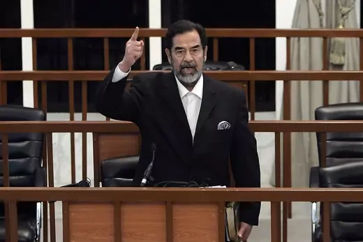 Saddam Hussein is seen gesturing and shouting during his trial.