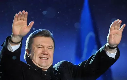 Viktor Yanukovich waves with both hands to his supporters during a rally in Kyiv.