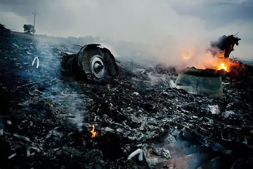 Debris from Malaysia Airlines Flight 17 burns in a field in eastern Ukraine.