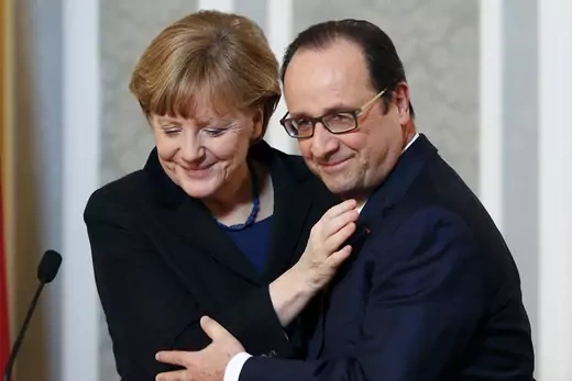 German Chancellor Angela Merkel hugs French President Francois Hollande after peace talks in Minsk.