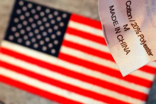 The label reading "Made in China" on a sweatshirt is seen over another shirt with a U.S. flag at a souvenir stand in Boston, Massachusetts January 18, 2011. 