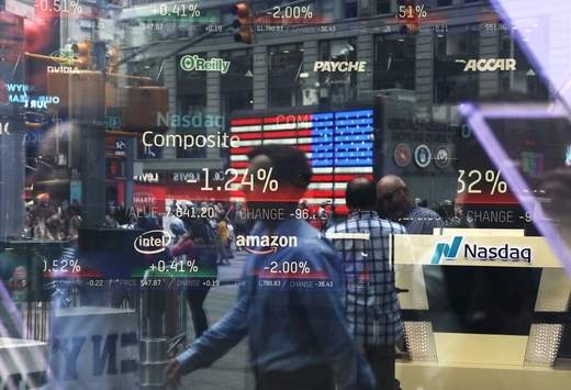 NEW YORK, NY - JULY 30: People are reflected in the window of the Nasdaq MarketSite in Times Square on July 30, 2018 in New York City. As technology stocks continued their slide on Monday, the Nasdaq Composite dropped 1.1 percent in afternoon trading with shares of Facebook, Netflix, Amazon and Google-parent Alphabet all declining.