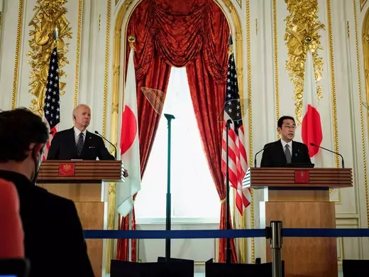 U.S. President Joe Biden and Japan Prime Minister Fumio Kishida stand at two podiums, Biden on the left and Kishida on the right. They are facing an audience.