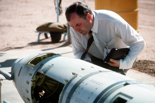 Photo showing a Soviet inspector examining a BGM-109G Tomahawk ground-launched cruise missile prior to its destruction.