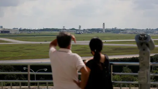 People look out on a U.S. military base in Japan. 
