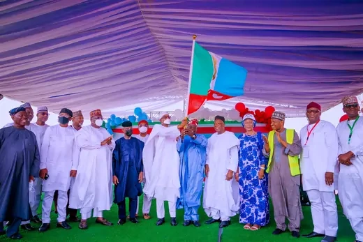 Nigeria's All Progressives Congress (APC) party stands together and waves their party flag. 