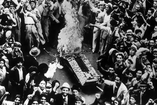 Crowds cheering as a coffin, representing an oil coffin, burns during celebrations in Mexico City of the government appropriation of foreign owned properties.   