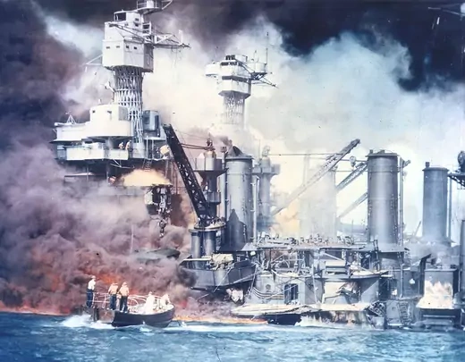 Thick smoke rolls out of a burning ship during the attack on Pearl Harbor by the Japanese. 
