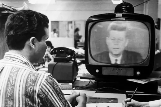 Man watches President Kennedy's television address.