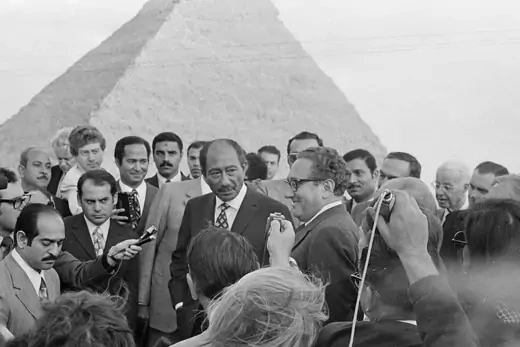 Egyptian President Anwar Sadat and U.S. Secretary of State Henry Kissinger during a press conference in front of Egyptian pyramid.