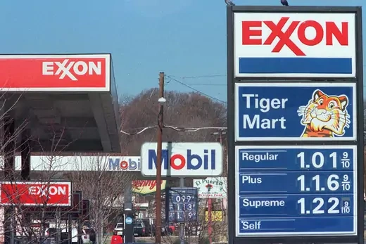 Photo showing Exxon and Mobil gas station signs.