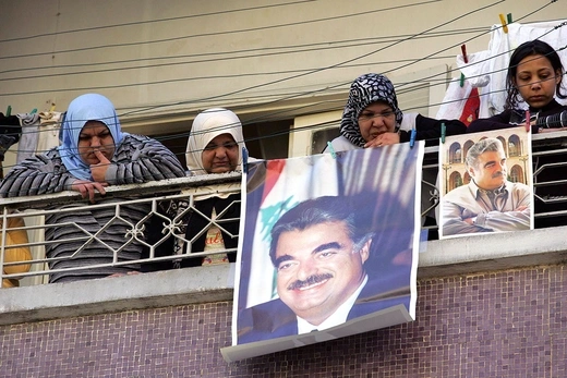 4 Sunni Muslim Lebanese women stand on their balcony with posters of assassinated former Lebanese Premier Rafiq Hariri.