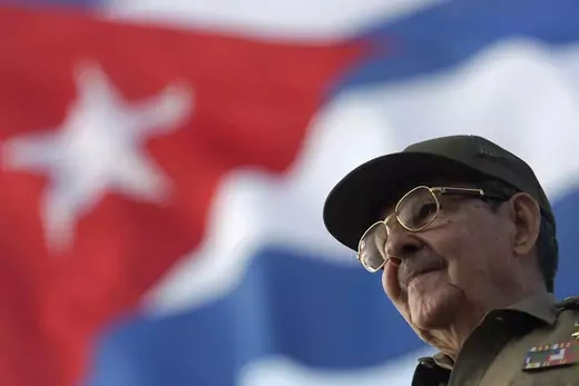 Cuban President Raul Castro is seen with Cuban flag in background.