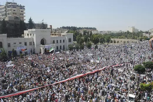 A giant Syrian flag is held by the crowd during a protest against President Bashar al-Assad.