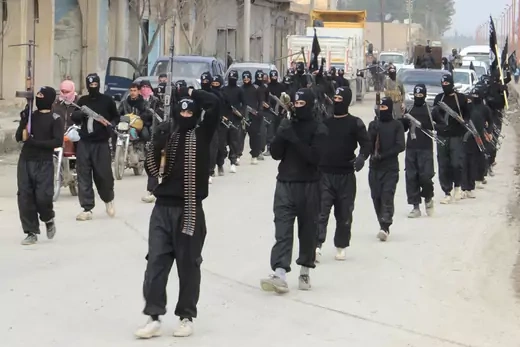 Fighters of  al-Qaeda linked Islamic State of Iraq and the Levant carry their weapons during a parade. 