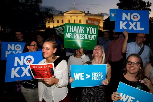 A small group of activists with signs reading "Thank You Mr. President" and "NO KXL", gather outside the White House to celebrate the Obama administration's rejection of the Keystone XL pipeline.