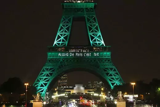 The Eiffel Tower is illuminated to celebrate the first day of the application of the Paris climate accord. A phrase on the tower reads: Accord de Paris, c'est fait.