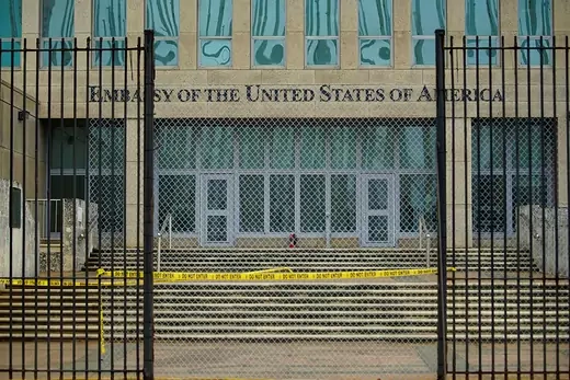 A picture of the U.S. Embassy Havana, with fencing and caution tape in the foreground.
