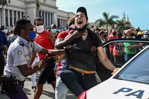 A man is seen screaming as he is arrested by police during a protest in Havana.