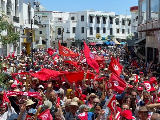 Demonstrators hold flags as they gather during a protest in opposition to a referendum on a new constitution called by President Kais Saied, in Tunis, Tunisia June 18, 2022.