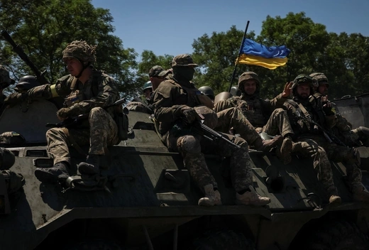 Ukrainian service members ride an Armoured Personnel Carrier (APC), in Donetsk region, amid Russia's attack on Ukraine July 7, 2022.