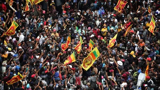 Protesters gather in a street leading to the Sri Lankan President's official residence