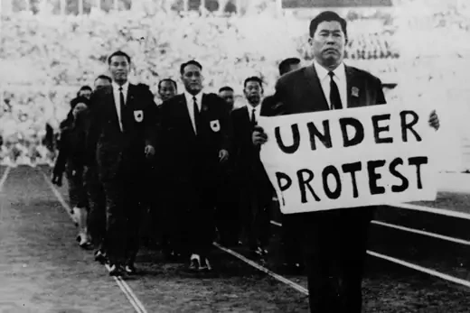 A member of the Taiwan team holds a sign reading Under Protest during the opening ceremony.