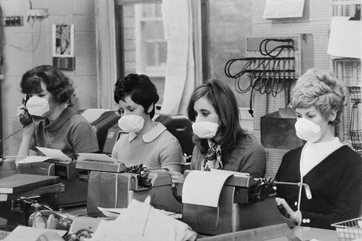 Office workers in London wear masks to try to avoid contracting the flu in December 1969.