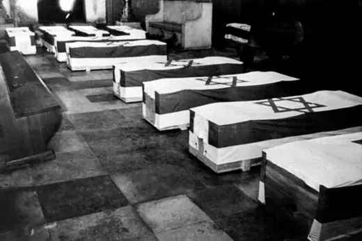 Coffins are covered with Israeli flags and laid in a synagogue in Munich.