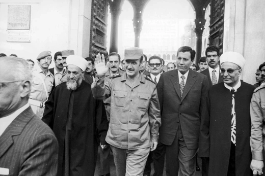 Syrian President Hafez al-Assad waves as he walks out of the Omayyades mosque in Damascus in October 1973. 